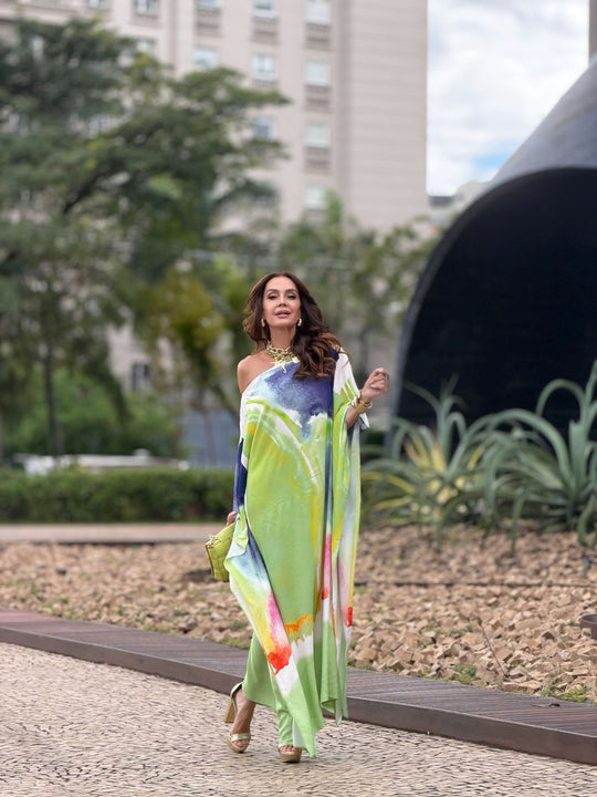 Mulher usando vestido kaftan longo em aquarela colorida, caminhando ao ar livre, elegante.